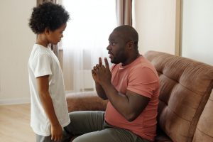 Father and son talking in their home.