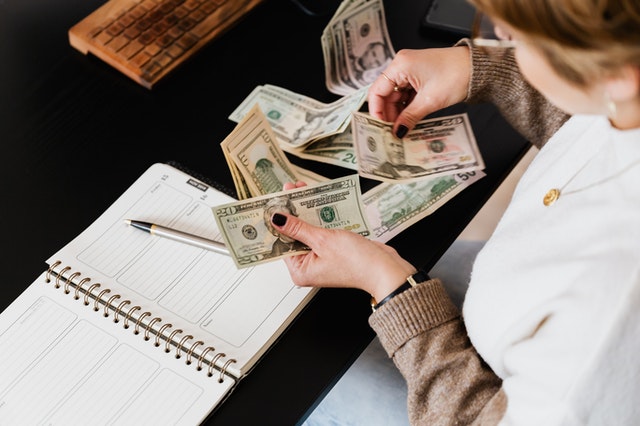 A woman counting money.