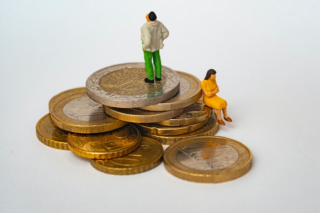 Tiny figurines of a man and woman on coins