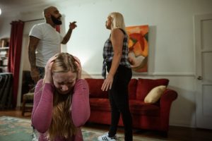 Couple arguing in front of their distressed daughter as an example of how social media impacts divorce