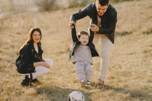 Divorced couple playing with their young son