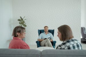 A couple on a couch during marital mediation.