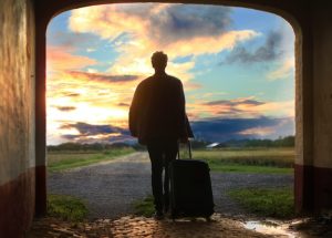 Man with suitcase going through a tunnel.