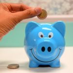 Putting money into a piggy bank for a divorce attorney in Florida