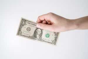 Close-up of a hand holding a dollar bill